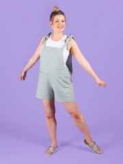 Model wearing short dungarees or overalls handmade using the Erin sewing pattern in light linen fabric