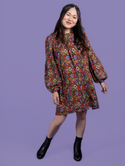 Model wearing a floral mini dress, made using the Marnie sewing pattern in viscose crepe.