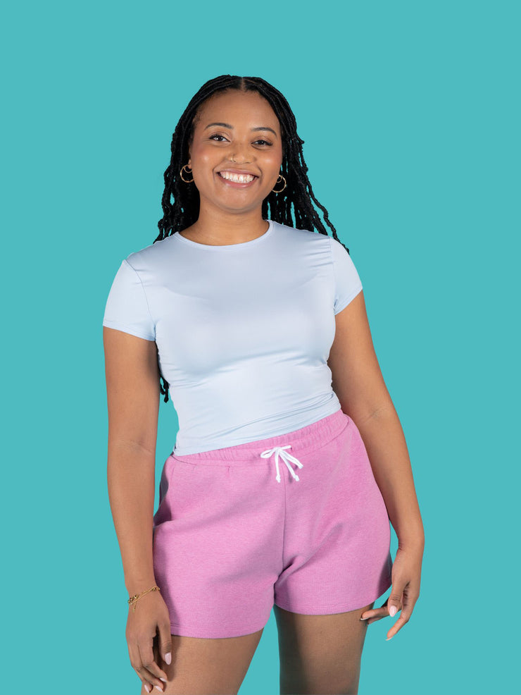 Model is wearing pink sweat shorts with drawstring made from the Tilly and the Buttons Cece joggers and shorts sewing pattern