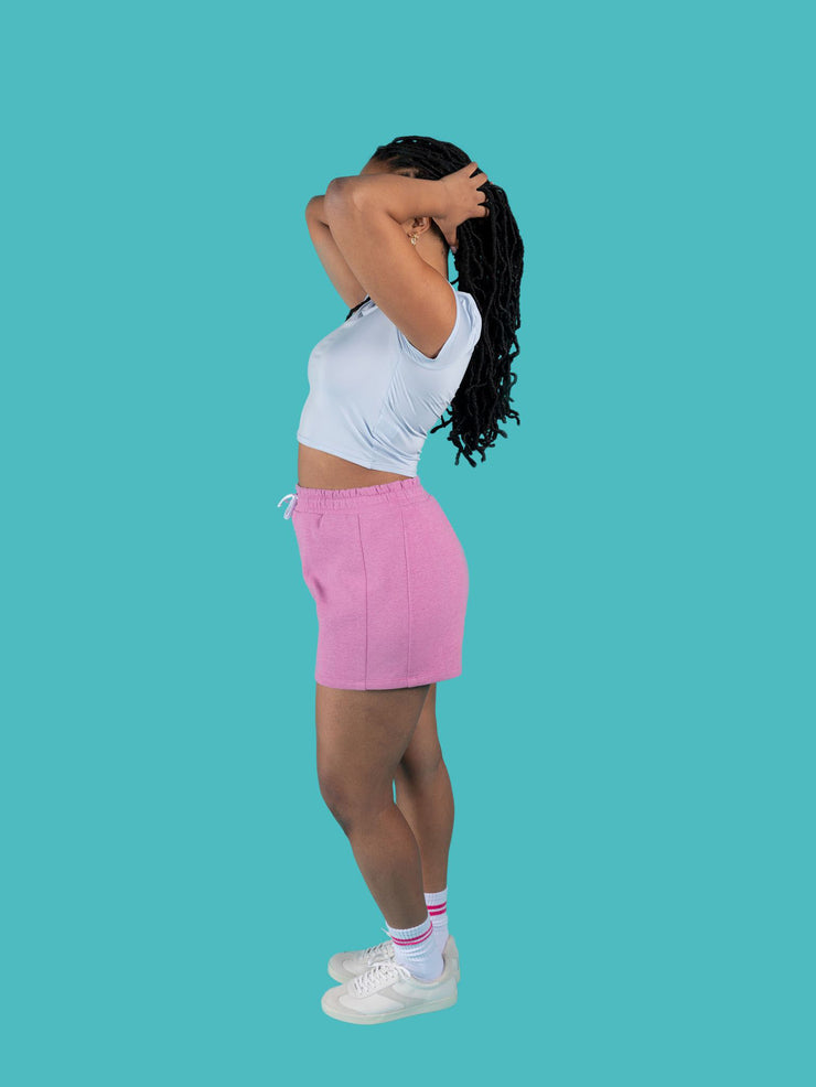 Side view of model wearing pink sweat shorts with drawstring made from the Tilly and the Buttons Cece joggers and shorts sewing pattern