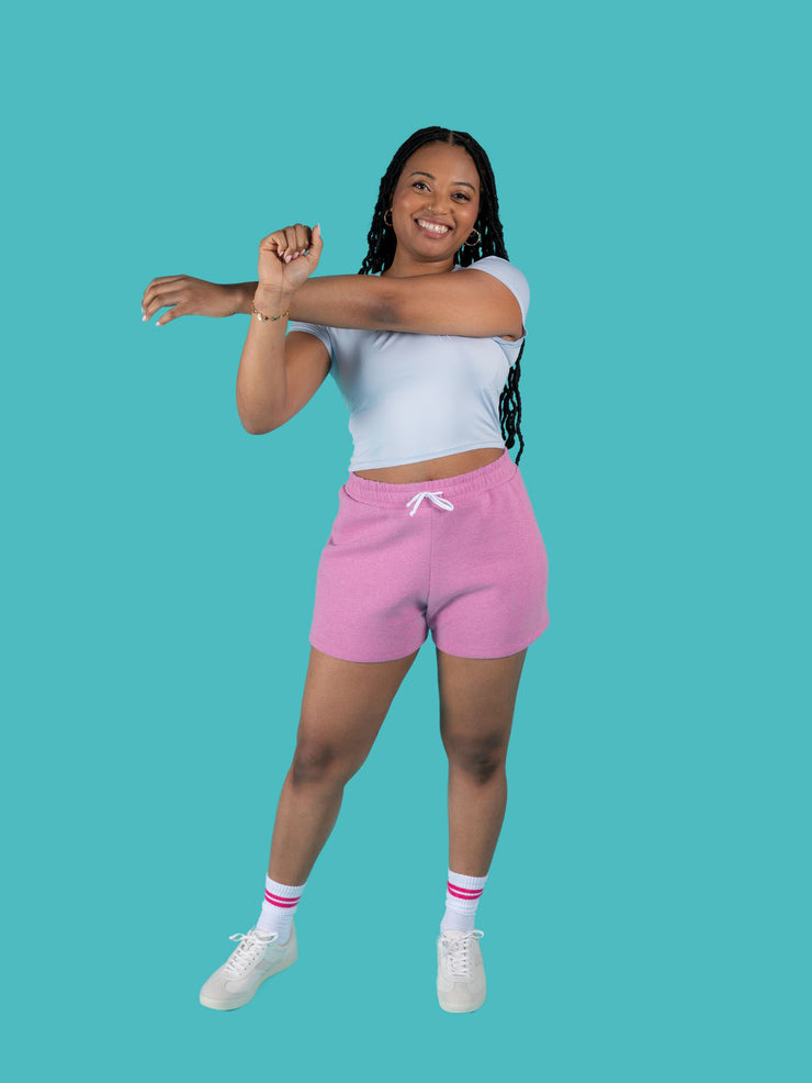 Model is wearing pink sweat shorts with drawstring made from the Tilly and the Buttons Cece joggers and shorts sewing pattern