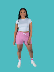 Model is wearing pink sweat shorts with drawstring made from the Tilly and the Buttons Cece joggers and shorts sewing pattern