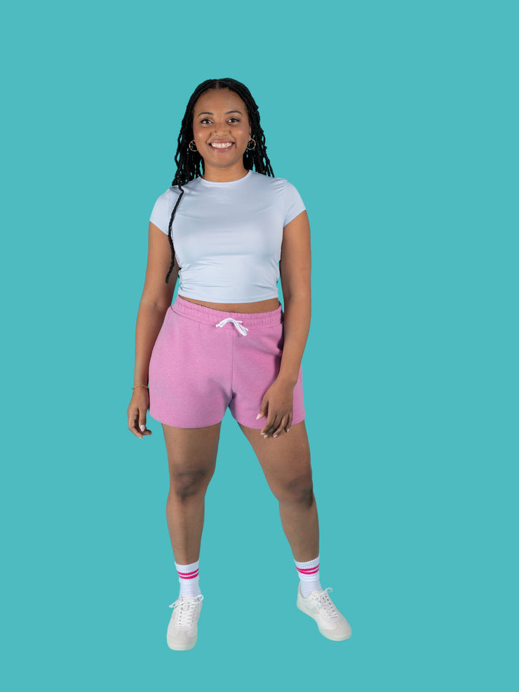 Model is wearing pink sweat shorts with drawstring made from the Tilly and the Buttons Cece joggers and shorts sewing pattern