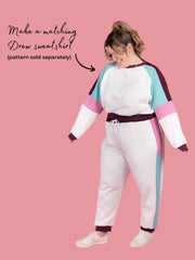 Plus size model wears Cece joggers sewing pattern from Tilly and the Buttons in white with colour block side panel and pockets. Text says make a matching Drew sweatshirt pattern sold separately.