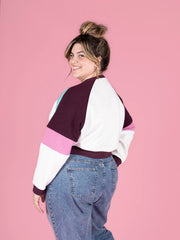 Model wearing the Tilly and the Buttons raglan sleeve sweatshirt in the colour block version, highlighting the stylish contrast of colors on the back of this versatile sewing pattern.