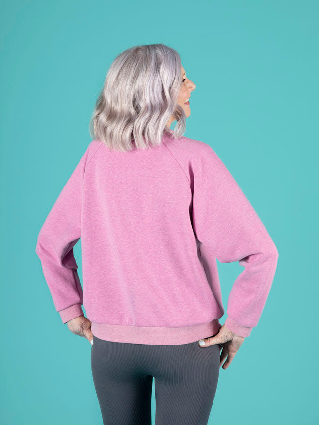 Model wearing the Tilly and the Buttons raglan sleeve sweatshirt in the solid colour version, highlighting the back view of the sweatshirt in this simple yet stylish sewing pattern.