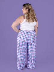 Back view of Jaimie pyjamas sewing pattern on plus size model in pastel tartan brushed cotton fabric