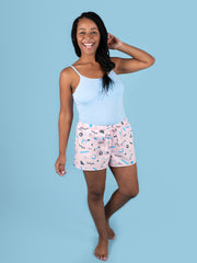 Model wearing a light blue tank top and patterned Jaimie pj shorts on a blue background