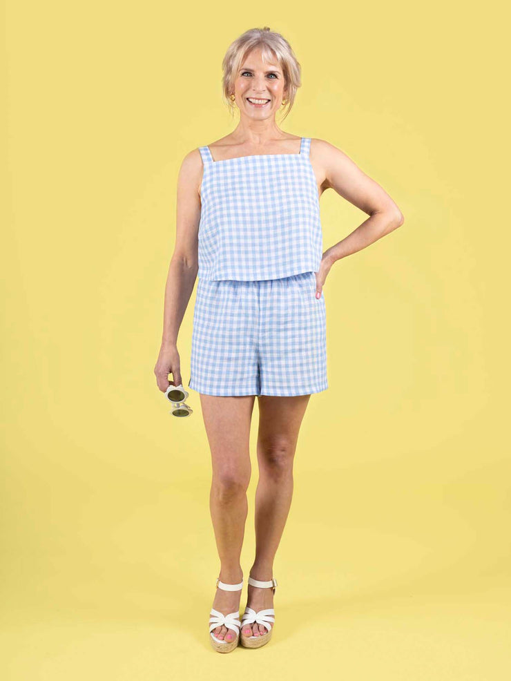 Model wearing a summery blue gingham shorts and top, made using the Esti co-ord sewing pattern