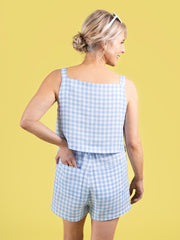 Back view of model wearing a summery blue gingham shorts and top with a hand in pocket, made using the Esti co-ord sewing pattern