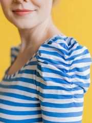 Model wears blue stripe jersey top with ruched sleeves
