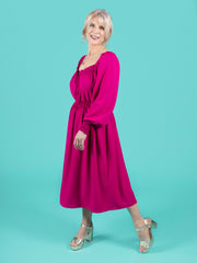 Model wearing a magenta shirred dress, made using Tilly and the Buttons Mabel sewing pattern