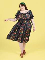 Plus size model wearing a floral shirred dress, made using Tilly and the Buttons Mabel sewing pattern