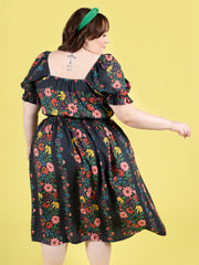 Plus size model wearing a floral shirred dress, made using Tilly and the Buttons Mabel sewing pattern