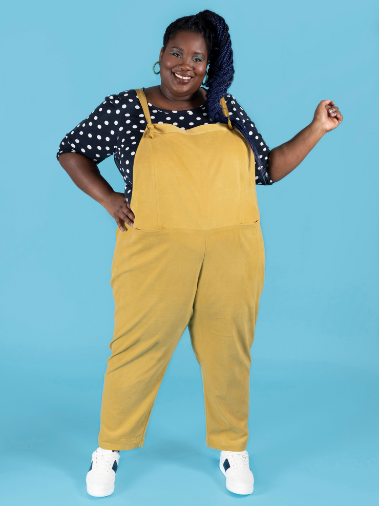 Curvy, plus size model wearing long dungarees or overalls handmade using the Erin sewing pattern