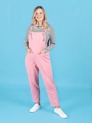 Model wearing long dungarees or overalls handmade using the Erin sewing pattern in stretch knit fabric