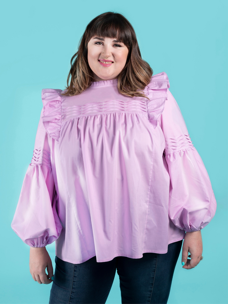 Model wearing a lilac blouse with tuck details, made using the Marnie sewing pattern in cotton lawn.