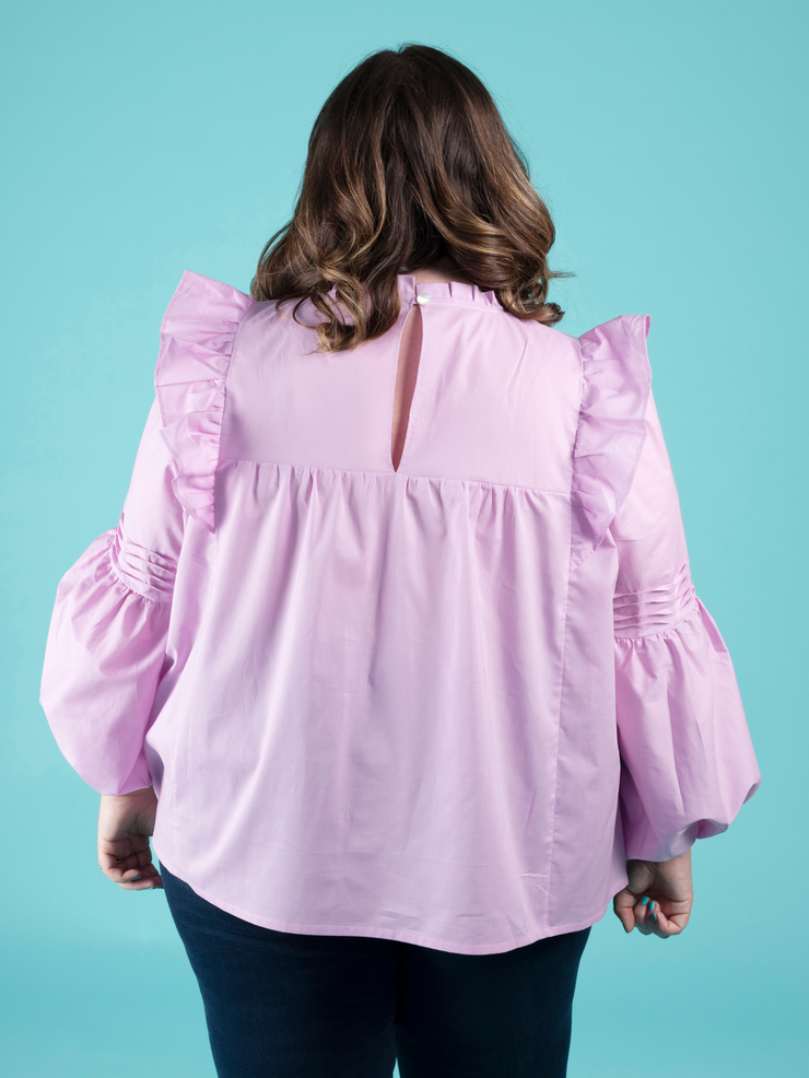 Back view of a model wearing a lilac blouse with tuck details, made using the Marnie sewing pattern in cotton lawn.