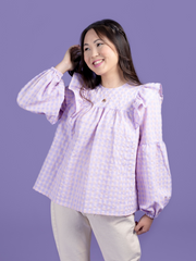 Model wearing a lilac and pink gingham blouse, made using the Marnie sewing pattern in cotton.