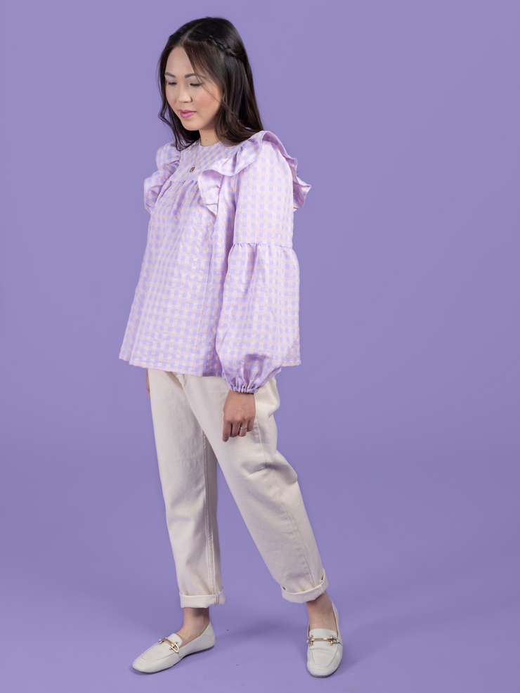 Model wearing a lilac and pink gingham blouse, made using the Marnie sewing pattern in cotton.
