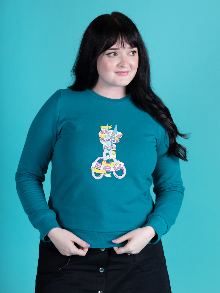 Abi Dyson wears a peacock colour Billie sweatshirt with &